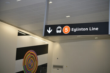 Fototapeta premium public art and suspending sign inside an Eglinton Line 5 station, Toronto