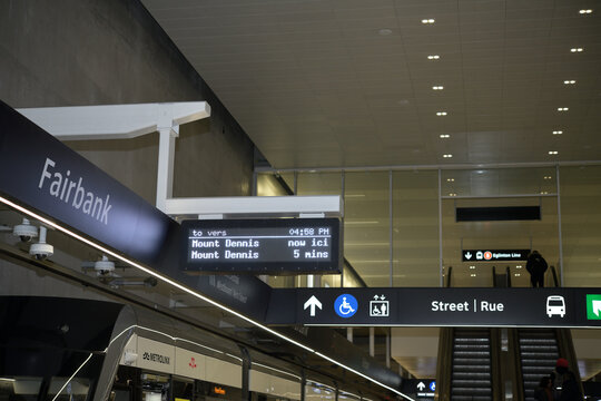 interior view of Fairbank station of the Eglinton Line 5, with signage and vehicle, Toronto