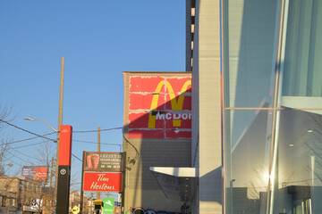 Fototapeta premium looking east on Eglinton Av outside Fairbank station of Line 5, with McDonald's ghost sign, incl Tim Hortons, southeast corner at Dufferin St, Toronto