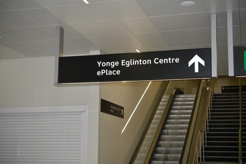Fototapeta premium suspending sign with direction to Yonge Eglinton Centre and ePlace inside Line 5/Eglinton Line station, Toronto