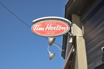 Fototapeta premium oval projecting sign outside Tim Hortons, a coffee shop chain, located here at 91 Danforth Av, Toronto