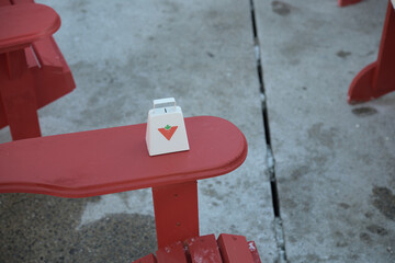 Fototapeta premium cow bell with Canadian Tire corporate logo on a lounge chair arm rest at Team Canada Fan Fest at Nathan Phillips Square, Toronto