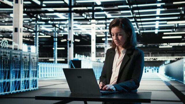 Data center engineer typing on laptop keyboard to troubleshoot supercomputers connectivity issues. Server hub expert using program on notebook to analyze system logs, fixing gear errors, camera A