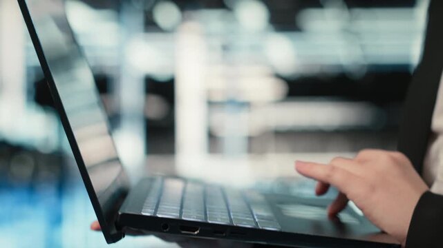 Close up of laptop software used by data center admin to troubleshoot supercomputers issues. Server farm employee analyzing system logs with notebook to resolve electronics errors, camera B