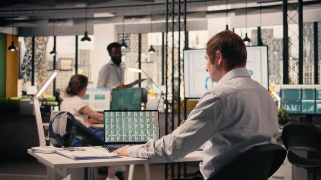 Professional man, business intel, visual data in office, analytics dashboard, performance metrics, forecasting reports, assisting with monetary data, resource allocation, and strategy planning.