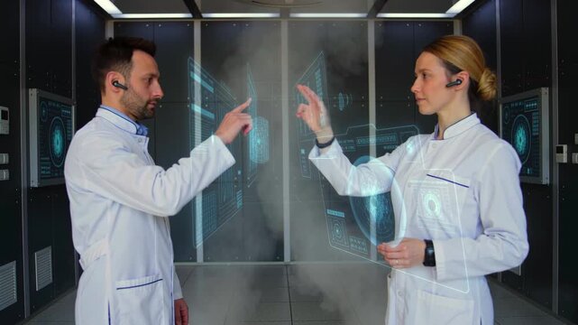 cleanroom researchers demonstrate collaborative holographic controls in secure facility, two scientists exchange gesture commands with projected panels, sterile corridor backdrop and procedural focus