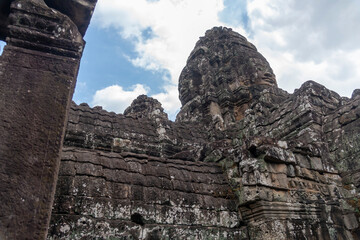 Angkor Thom, Siem Reap, Cambodia.  The Bayon temple, a major attraction - detail of faces on the towers