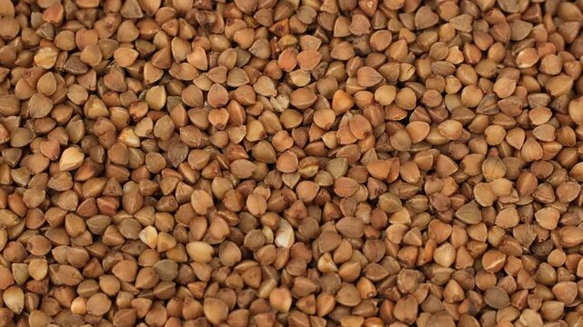 Heap of raw buckwheat close up, slider view
