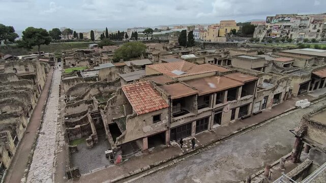 video of the Herculaneum excavations on a cloudy day, showing ancient Roman ruins and streets preserved by Mount Vesuvius near Naples, Italy.