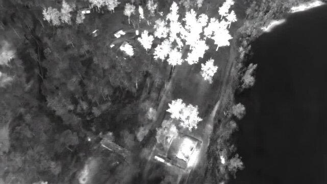 Tactical thermal surveillance of industrial harbor with digital crosshair overlay