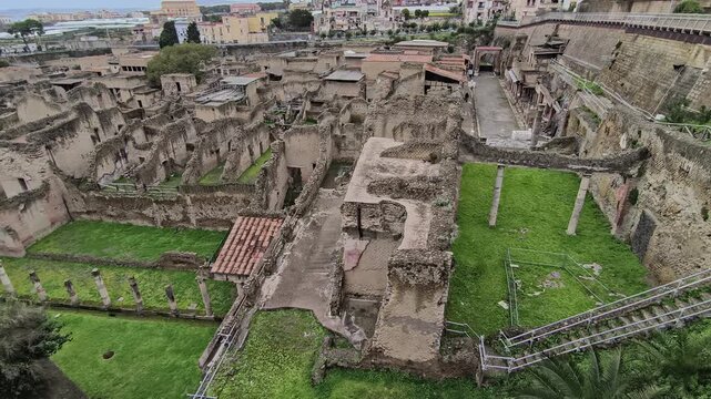 video of the Herculaneum excavations on a cloudy day, showing ancient Roman ruins and streets preserved by Mount Vesuvius near Naples, Italy.