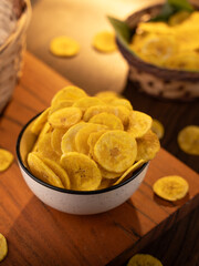 Banana chips a Indian snacks served in a bowl on lifestyle setup. © sdx15