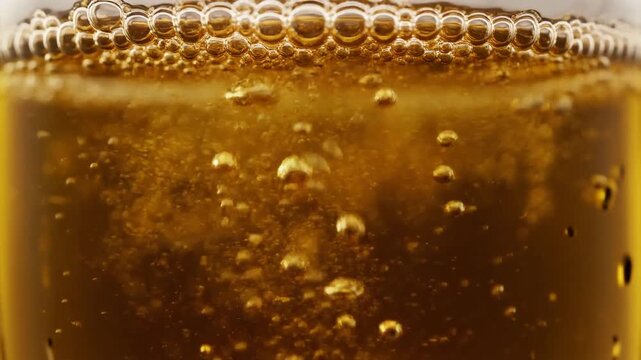 Golden Carbonated Beverage Bubbles Close Up.