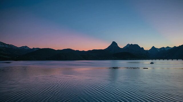 Drone flying over Ria&ntilde;o reservoir at blue hour in Le&oacute;n, Spain, with calm water and mountains
