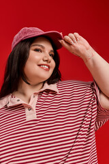 Naklejka premium Stylish plus size woman radiates confidence in vibrant red setting