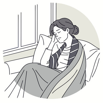 Woman resting on couch by window with blanket