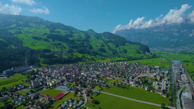 Aerial panoramic view around the old town city of Flums  in Canton Sankt Gallen in Switzerland on a sunny spring day.