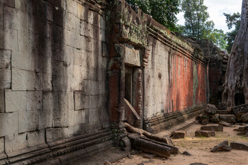Angkor Thom, Siem Reap, Cambodia.  Ta Prohm temple with trees and roots clinging to the stonework - colours and doorway