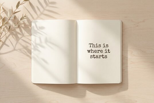 Minimal desk scene with an open notebook showing the words &ldquo;This is where it starts.&rdquo; Quiet motivation, new beginnings, and personal growth concept with soft natural light.
