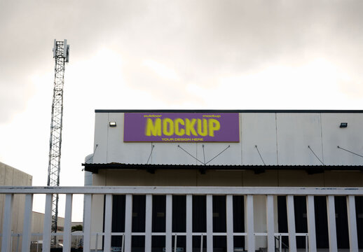Real photo of Building With Blank storefront Sign on Cloudy Day. PSD mockup.