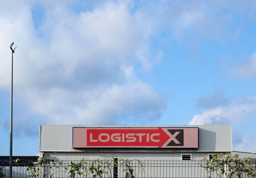 Real photo of warehouse storefront panel sign. PSD mockup template.