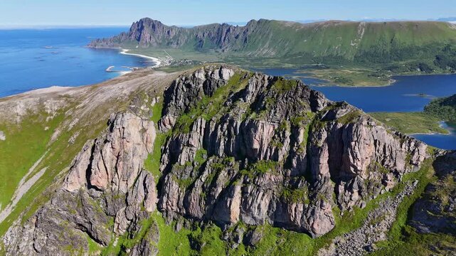 Forward turn drone flight above  ocean, towards M&aring;tind, Matind mountain on Vesteralen, Vester&aring;len islands. Bleikmorenen en bleik visible. Amazing nature, outdoor travel destination, hiking area. Beaut