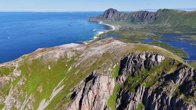 Forward turn drone flight above Laupen mountain peak and ridge on Vesteralen, Vester&aring;len islands. Bleikmorenen en bleik visible. Amazing nature, outdoor travel destination, hiking area. Beautiful natu