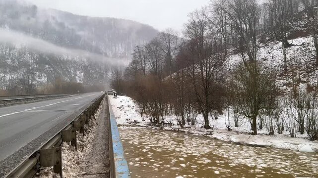In the Carpathians, a mountain river is drifting with ice. The swift current carries cold ice floes. Spring is coming to the mountains, and warmer weather is on the way.