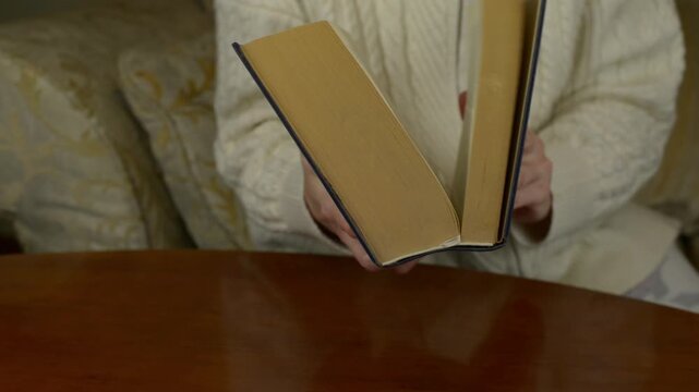 Hands closing a thick big book. Close up shot of heavy pages and hardcover shutting with sound