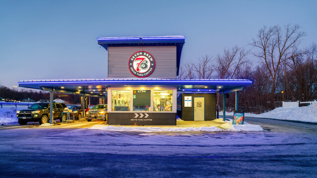 New Hartford, NY - Feb 1, 2026: 7 Brew (7B) Coffee-shop exterior in night view, 7B is a drive-through only coffee chain known for its double drive-thru lanes, focus on speed, and customer service