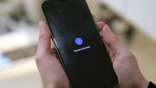 User unlocks private data. Close-up of blue icon and Access Granted notification. Ideal for online banking, IT security, and mobile app marketing. Modern dark mode interface for professional business