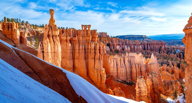 Wide-angle panorama of Bryce Canyon National Park in Utah (USA) on a sunny, cold morning in March with snow. The unique landscape of orange-red sandstone formations known as &ldquo;hoodoos&rdquo; is a natural sen