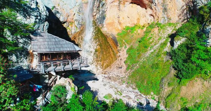Waterfall and mountain hut aerial view