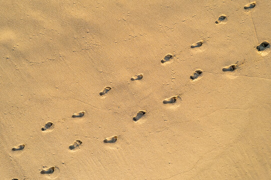 Aerial View of Couple&rsquo;s Footprints in the Sand on a Beach