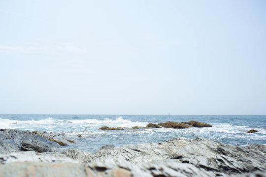 Rhode Island New England coastal rocks and shoreline along the frigid Atlantic seaboard with current wave swells and storm surges during hurricane season