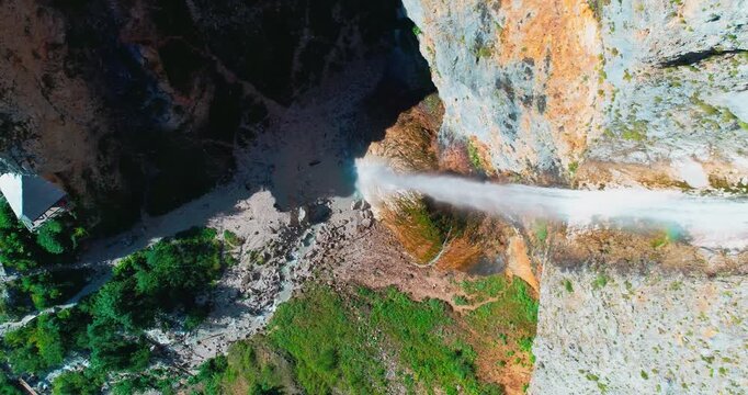 Close aerial of waterfall splash