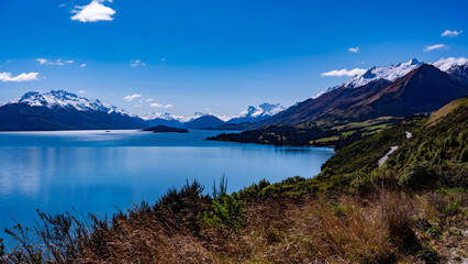 Fototapeta premium Alpine Lake with Snow-Capped Mountains and Wilderness