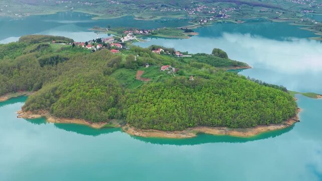 Aerial of green island in lake