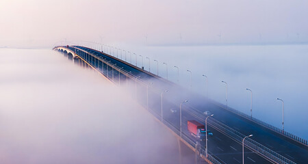 Highway Bridge Through Dense Morning Fog with Truck Traffic