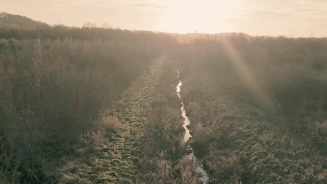  vintage look small stream of water going in to the sunset