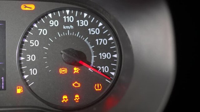 Car dashboard speedometer with warning lights changing at different speeds animation