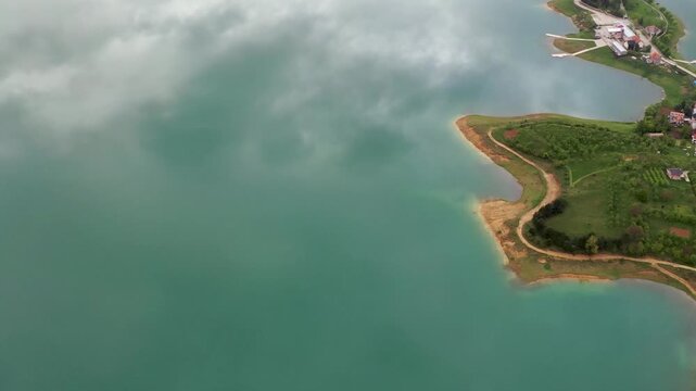 Drone view of curved lake shoreline