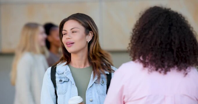 Two women meeting by building entrance denim-jacket woman checking watch after buzz holding coffee