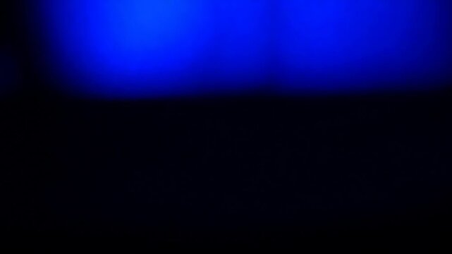 Abstract neon light leaks flashing on a dark background