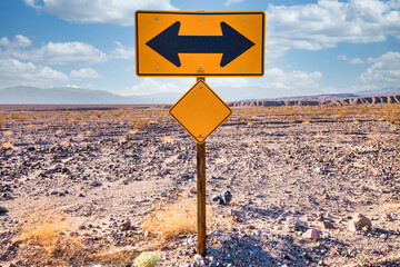 Direction sign in the desert under a blue sky. Concept of uncertain, risk, choice, decision