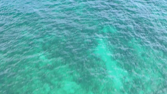 Top down drone view of shallow turquoise water texture