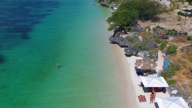 Top down drone view of calm lagoon meeting sandy beach