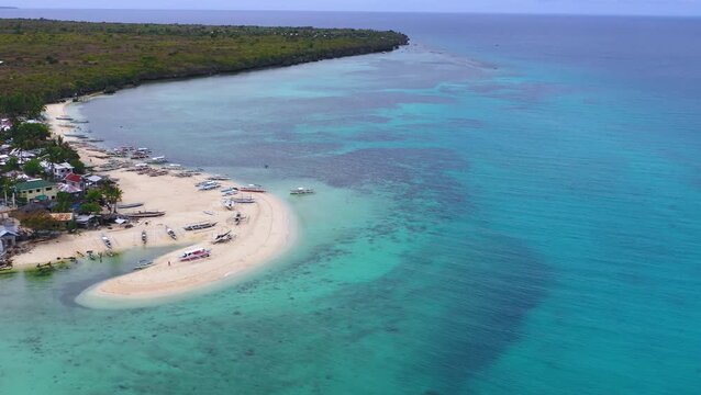 Aerial view of white sand spit and vivid blue sea