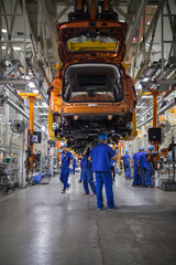 Obraz premium Automobile Assembly Line Factory Workers in Modern Industrial Workshop