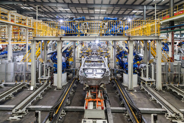 Fototapeta premium Robotic Welding Arm Assembly Line in Automobile Factory Production